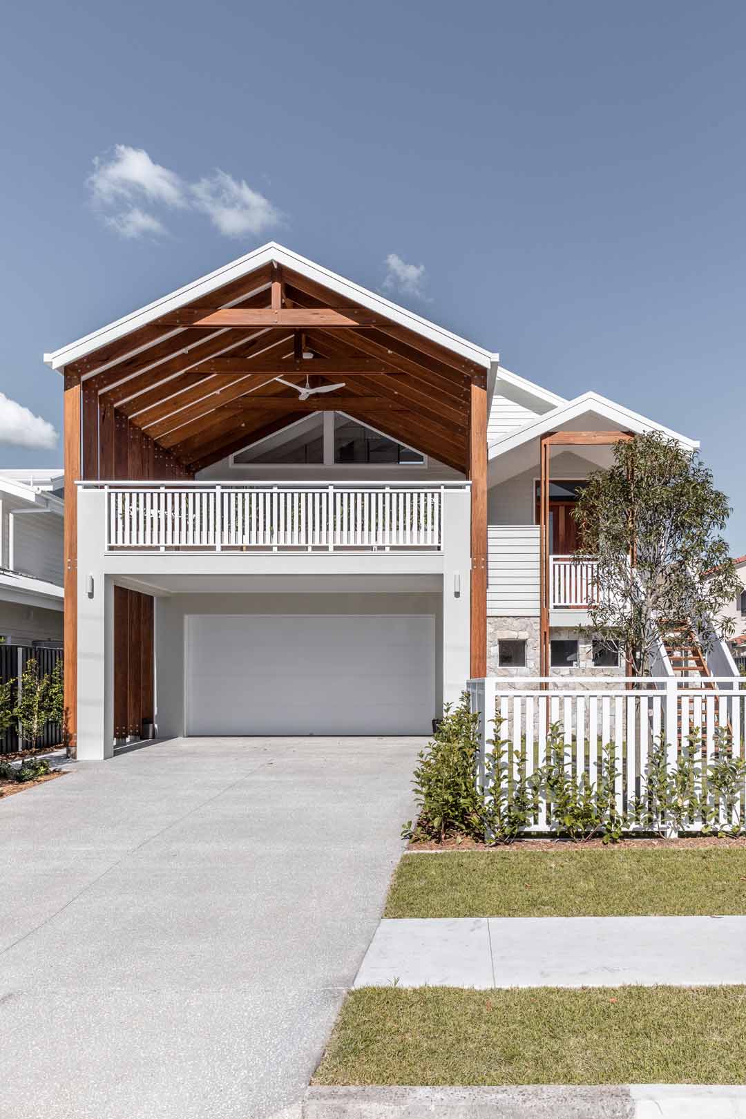 A-bold-queensland-coastal-home-front-facarde-with-a-large-timber-pavillion-and-white-picket-fence